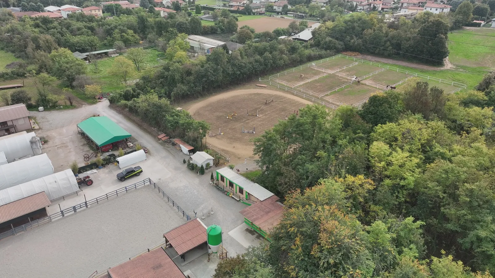 The riding centre surrounded by greenery, seen from the drone